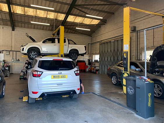Vehicle Servicing at Dowleys - Pickup and Cars in Service Bay